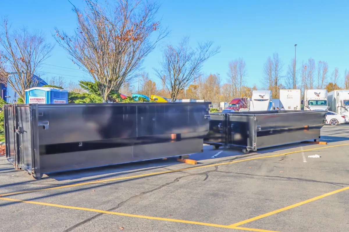 Professional dumpster rental service with roll-off container on residential driveway in Gladstone